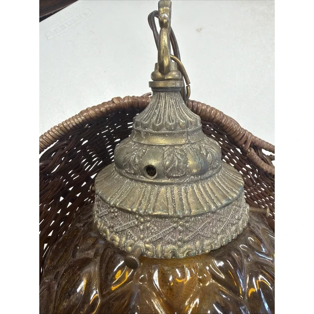 vintage mid-century modern hanging lamp features a distinctive amber glass globe
